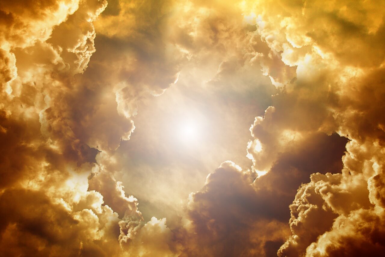 smoke filled sky with sunshine peeking through